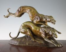 A French Art Deco patinated bronze group of two running greyhounds, on oval base signed Francisque