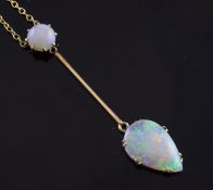 A 9ct gold and white opal drop pendant necklace, set with round and teardrop shaped opals, on a fine