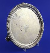 A William IV silver circular waiter by Charles Thomas Fox, with gadrooned border, on ornate scroll