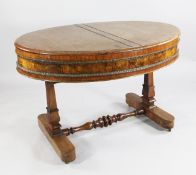 A 19th century Continental mahogany and walnut drum top oval centre table, with hinged D end and