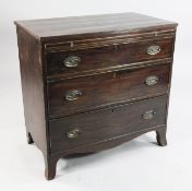 An early 19th century mahogany straight front chest, of three long graduated drawers with brushing