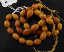 A single strand oval amber bead necklace, gross 26 grams, string damaged, bead to bead 19.25in.
