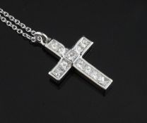 An 18ct white gold and diamond cross pendant, 0.75in. on fine chain