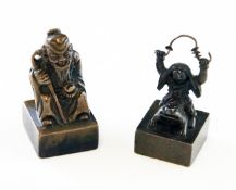 Two Chinese small bronze figural seals, 19th century, the first modelled as the seated figure of