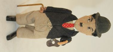 A Schuco 940 Charlie Chaplin wind-up toy, c.1930s, in the character of the little tramp with a