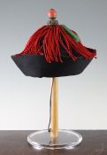 A Chinese Mandarin Official`s Zhao Guan (court hat), c.1900, of dark purple satin and black velvet