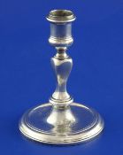 A George I cast silver taperstick by Simon Pantin, with engraved armorial and waisted turned stem,