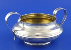 A Victorian silver two handled sugar bowl, with banded girdle and reeded handles, Frederick Francis,