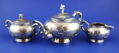 A late 19th/early 20th century Chinese three piece silver tea set by Kwan Wo, Canton or Hong Kong,