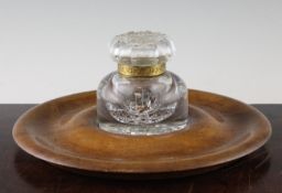 A large Victorian glass inkwell, with hobnail cut lid and base, together with a circular walnut