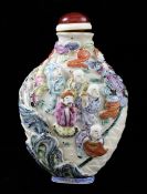 A Chinese moulded famille rose `immortals` snuff bottle, Qianlong mark, 1820-50, one side