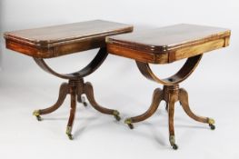 A pair of Regency mahogany folding card tables, with boxwood inlaid decoration and rounded