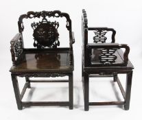 Two similar Chinese rosewood elbow chairs, late 19th century, the first with floral scroll carved