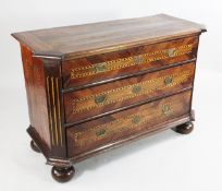 An 18th century Dutch walnut chest, of three long drawers with chequer inlay, projecting canted