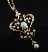 An Edwardian Art Nouveau 9ct gold, turquoise and seed pear set drop pendant, of open scroll form,