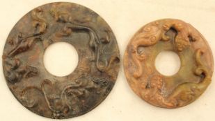 Two Chinese archaistic bowenite bi discs, both carved in relief with chi-dragons and scrolls to