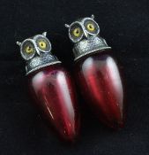 A pair of Edwardian novelty silver mounted ruby glass owl scent bottles by Sampson Mordan & Co, with
