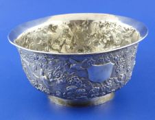 A late 19th/early 20th century Chinese silver bowl, embossed with birds amongst prunus on a textured