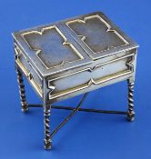 A George V novelty silver trinket box modelled as a Jacobean side table, with twin rising flaps,
