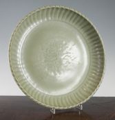 A Chinese Longquan celadon dish, Ming dynasty, of unusual form with an upturned scalloped edge,