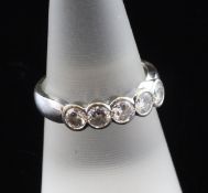 An 18ct white gold and five stone diamond half hoop ring, the collet set stones with an estimated