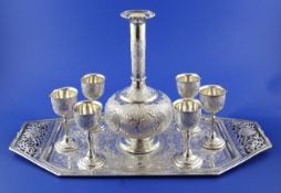 A Persian silver tray of octagonal for with pierced inset handles and engraved with scrolling