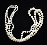 An early 1960`s double strand graduated cultured pearl necklace with 9ct white gold oval clasp,