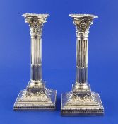 A pair of late Victorian silver corinthian column candlesticks, with harebell and swag decoration to