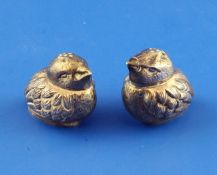 A pair of Chinese novelty silver pepperettes modelled as chicks, character mark signature to base,
