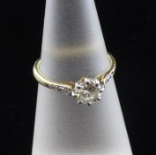 An 18ct gold and solitaire diamond ring, with diamond set shoulders, size K.