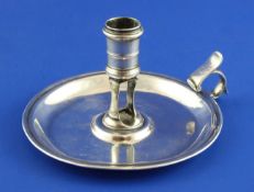 A George II chamberstick, with flying scroll handle and thumbpiece with engraved initial, James