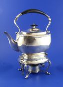 A George V silver tea kettle on stand with burner, of rounded rectangular form, with reeded borders,