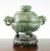 A unusual Chinese spinach green jade archaistic tripod censer and cover, 18th century, the rounded