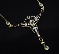 An Art Nouveau style 15ct gold, peridot and old cut diamond set pendant necklace, of stylised scroll