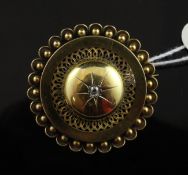 A Victorian 15ct gold and diamond set circular brooch, with pierced band, beaded border and glazed