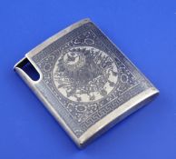 An early 20th century Ottoman silver and niello cigarette case, of concave form, decorated with