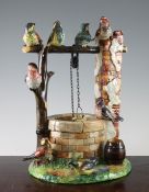 A Delphin Massier Vallauris majolica wishing well group, late 19th century modelled naturalistically