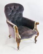A Victorian button back armchair, with scroll carved show frame and serpentine seat and castor feet
