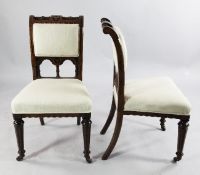A set of four Victorian gothic walnut and ebony inlaid dining chairs, one with a plaque for Brew &
