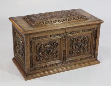 A Victorian carved oak tea chest, housing three painted toleware canisters, one for Green Tea and