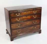 A George III mahogany chest, of four long graduated drawers with brushing slide, on bracket feet,