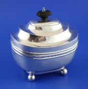 A late Victorian silver tea caddy, of ovoid form, with hinged lid and banded girdle, on ball feet,