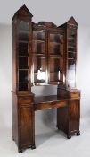 An unusual William IV mahogany secretaire bookcase, fitted a central pair of concave glazed doors
