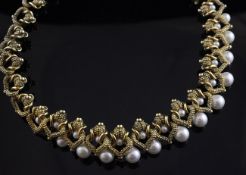 A silver gilt and graduated simulated pearl necklet, with shaped "cobbled" links.