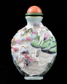 A Chinese moulded famille rose snuff bottle, Qianlong mark, 1820-1850, decorated to one side with