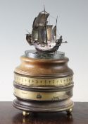 A St James` House Company mariner`s world clock, surmounted with a silver model of the Golden