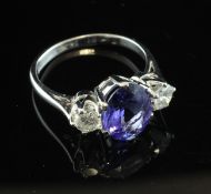 An 18ct white gold, tanzanite and diamond three stone ring, the central stone approximately 2.