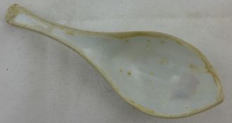 A Chinese Dehua blanc-de-chine spoon, 17th / 18th century, of boat form with a flowerhead