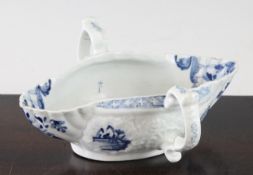 A Worcester small double lipped two handled sauceboat, c.1755-58, painted in underglaze blue with