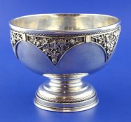 An Arts & Crafts silver pedestal rose bowl, of planished circular form, the border decorated with